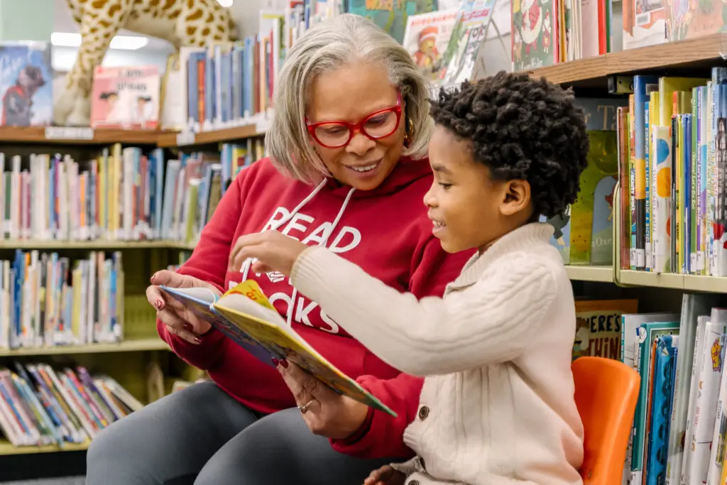 Librarian reading with student